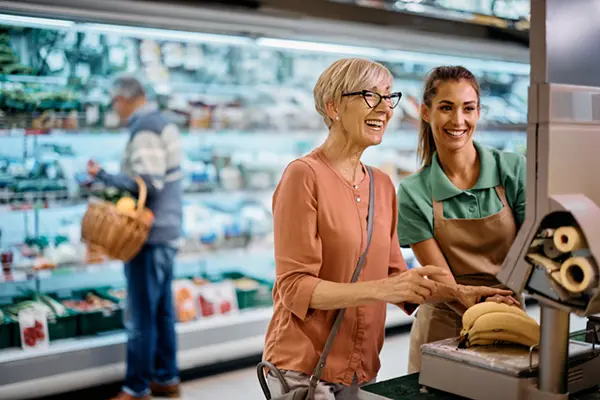 Picture of a woman helping an elderly lady with her shopping